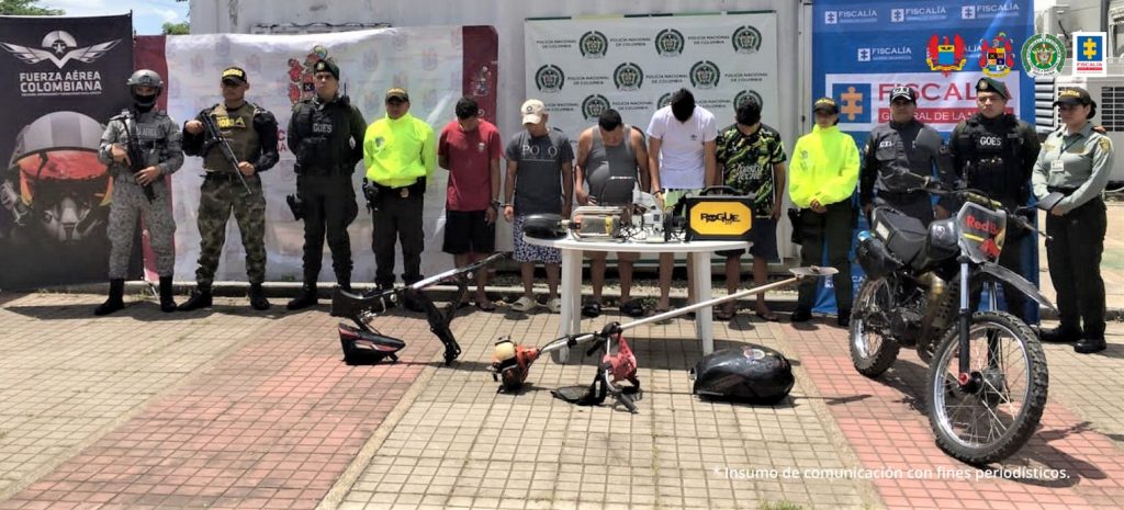Los capturados aparecen esposados y custodiados por servidores del CTI, y de miembros de la Policía, Ejército, Fuerza Aérea, en una mesa están algunos de los elementos hurtados.