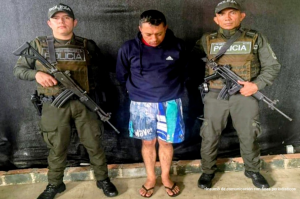 En la imagen se ve a un hombre capturado junto a dos uniformados de la Policía Nacional.