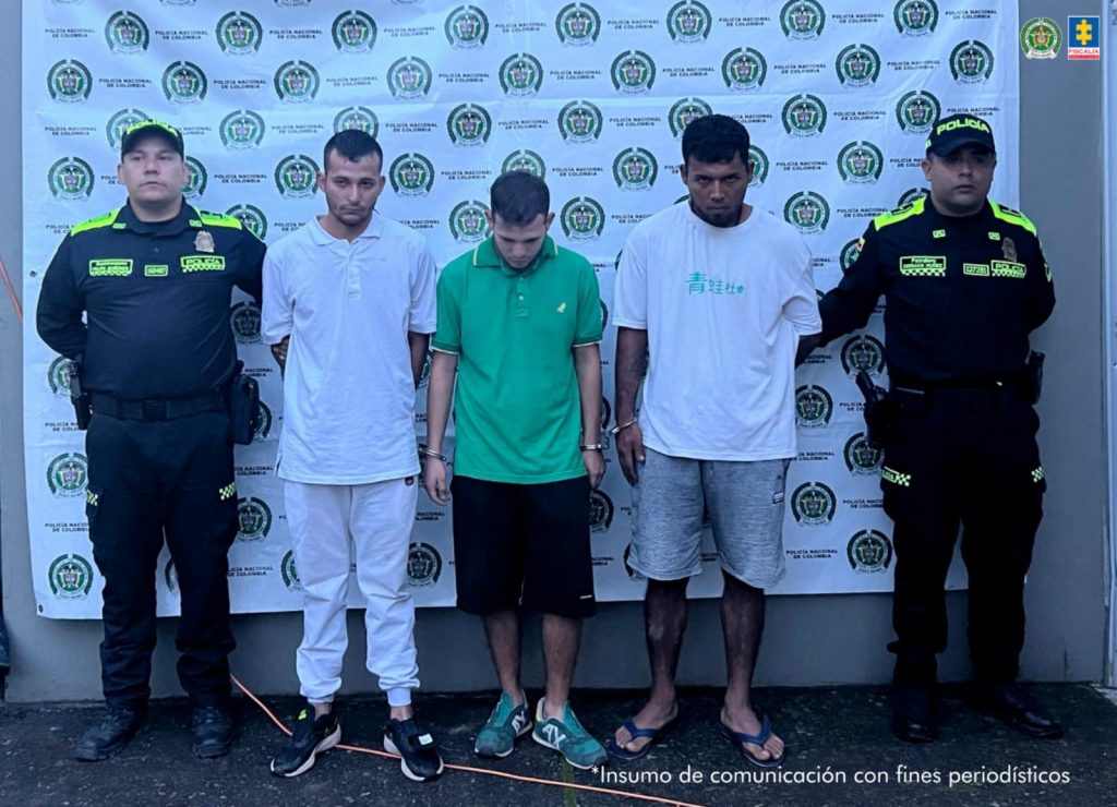 En la foto se observa a los tres capturados custodiados por dos uniformados de la Policía Nacional. Detrás hay un backing de la Policía Nacional.