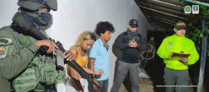 En la imagen se aprecian dos personas capturas, entre uniformados del CTI y la Policía.