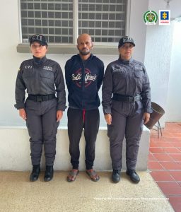 En la imagen está el procesado con 2 mujeres del CTI a sus lados