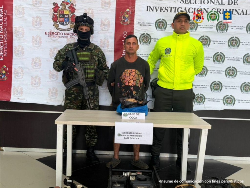  Se visualiza al capturado junto a uniformados del Ejército y Policía Nacional.  Frente a ellos una mesa con la sustancia incautada.