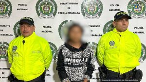 Se observa al capturado, con el rostro cubierto por un efecto de difuminado, en medio de dos funcionarios de Policía Nacional.
