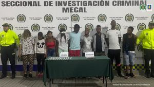 En la fotografía aparecen de pie los presuntos integrantes del grupo delincuencial Los del Principal o Tura. A los extremos de ellos hay uniformados de la Policía Nacional. Delante de ellos hay una mesa con mantel verde y sobre ella se parecían dos letreros que dicen: ´Cocaína’, ‘Marihuna’. Asimismo, hay bolsas plásticas pequeñas con contenido blanco y una mediana con contenido verdoso. Detrás de ellos hay un pendón institucional de la Policía.