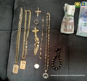 En la fotografía se aprecian 11 joyas (tres cadenas con sus respectivos dijes, un anillo, una manilla con un cristo, un dije en forma de cruz y uno redondo y una manilla redonda de color negro con pepitas doradas).