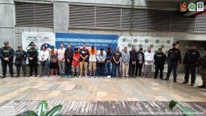 En la imagen están los 17 procesados con el pendón de la Fiscalía General de la Nación y servidores del CTI, la Policía y el Ejército Nacional