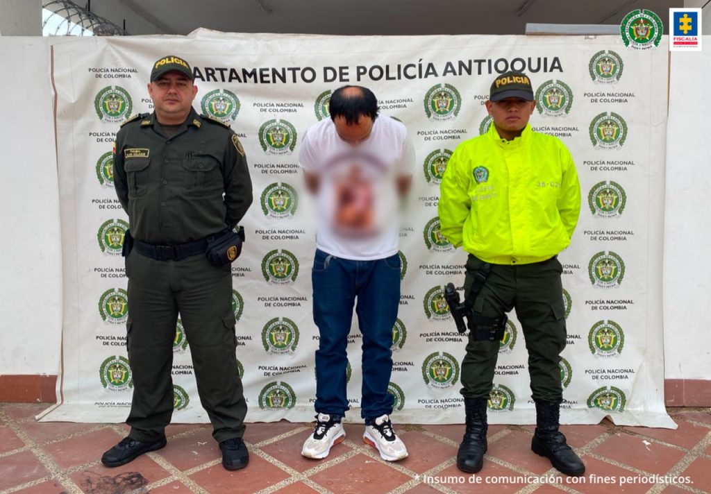 En la fotografía se encuentra el procesado en medio de dos servidores de la Policía Nacional. 