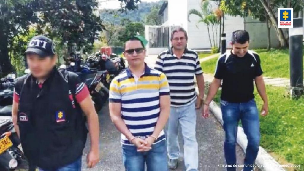 En la imagen se ven tres personas detenidas en compañía de un investigador del CTI.
