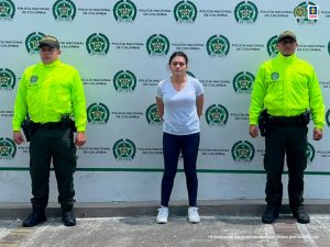 : En la imagen se ve una mujer detenida en cuastodia de dos uniformados de la Policía.