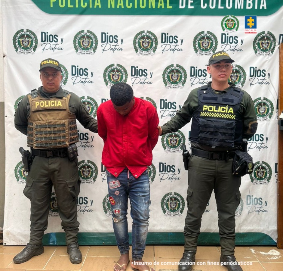 En la imagen aparece el presunto responsable de dar muerte a su pareja en Apartadó (Antioquia), está en medio de 2 patrulleros de la Policía