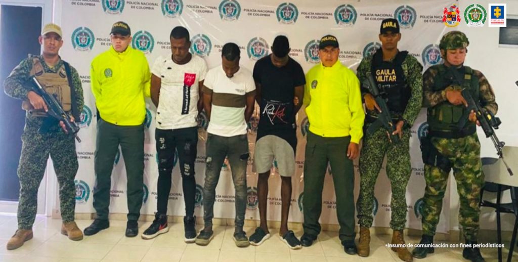 En la fotografía aparecen los tres capturados, junto a dos agentes de la Policía Nacional y, unidades del Gaula Militar y del Ejército Nacional. En la parte superior aparece un banner de la Policía Nacional.