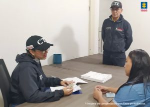 En la fotografía aparece una mujer, acompañada de dos servidores del CTI.