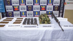 El material incautado se encuentra en una mesa blanca y detrás hay un backing del Ejército Nacional.