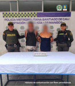 En la fotografía aparecen los capturados junto a dos uniformados de la Policía. En la parte superior está un banner de la Policía Nacional