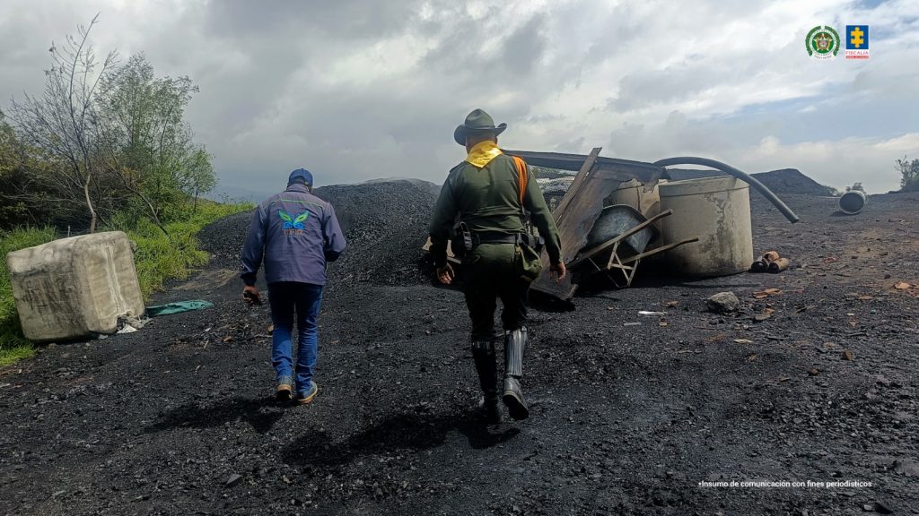 En la fotografía se observa un uniformado de la Policía Nacional y un funcionario de la Corporación Autónoma Regional de Cundinamarca, donde descubrieron una quema a cielo abierto donde se estaría adelantado la actividad ilegal, generando daños graves al suelo y su vegetación.