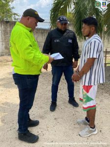 En la imagen se ve una persona al momento de su detención, entre un investigador del CTI y un policía.