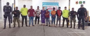 En la fotografía aparecen seis personas capturadas, acompañados de servidores del (CTI), uniformados de la Policía y el Ejército Nacional. En la parte posterior un banner con logos de la Fiscalía.