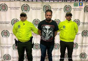 En la imagen está Sebastián Ospina Cano con dos servidores de la Policía Nacional y un pendón de la misma entidad en la parte de atrás