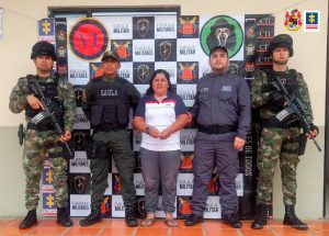 En la fotografía aparece un capturado, junto a personal de Policía Nacional y Ejército Nacional. En la parte posterior de la imagen se ven banners de Ejercito Nacional, Policía Nacional y la Fiscalía General de la Nación.
