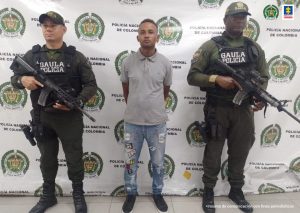 n la fotografía aparece el capturado junto a dos agentes del Gaula de la Policía Nacional. En la parte superior se observa un banner de la Policía Nacional