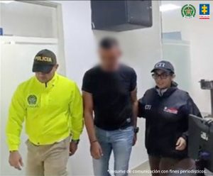 En la imagen se aprecian tres personas entre uniformados de la Policía Nacional y del CTI.