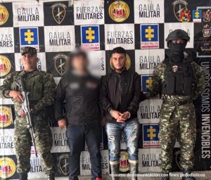 en la imagen se ve una persona detenida bajo custodia de integrantes del CTI y Ejército. Detrás suyo un backing institucional.