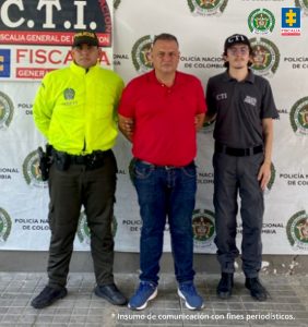 En la imagen se ve una persona detenida bajo custodia de un integrante del CTI y de la Policía Nacional. Detrás suyo un backing institucional.